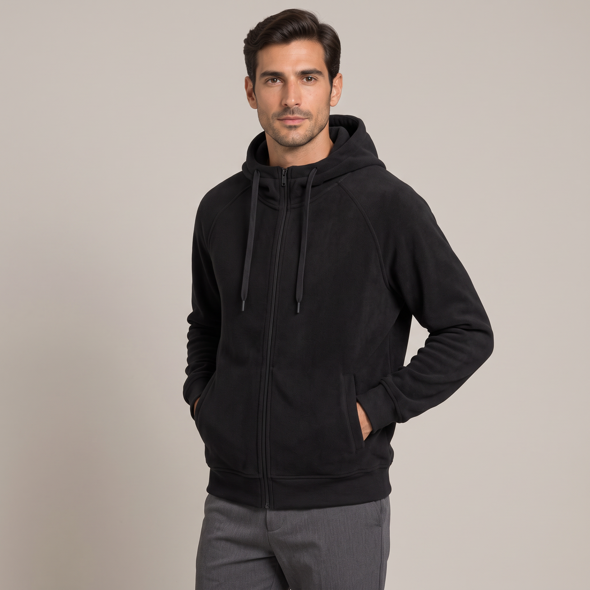 Men's black zip-up hoodie, three-quarter view with hands in pockets