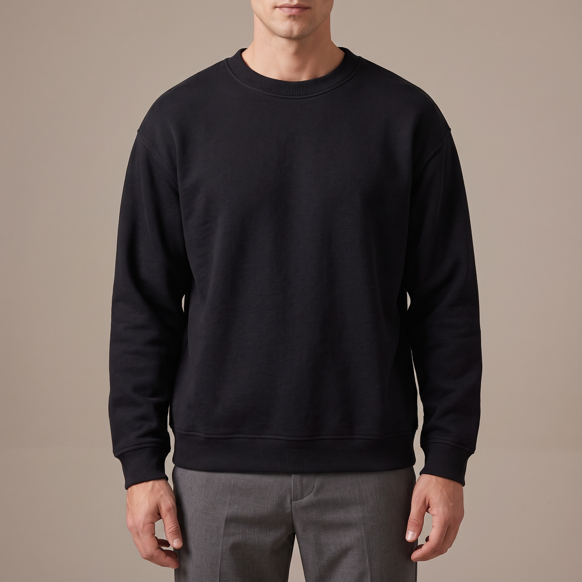 Close detail of the ribbed crew neck and dropped shoulder seam, in black