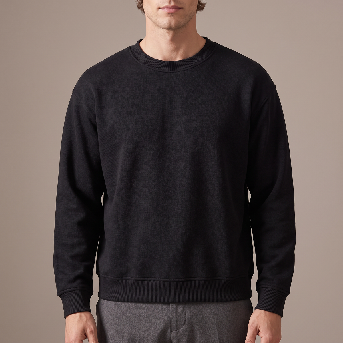 Close detail of the ribbed crew neck and dropped shoulder seam on the oversized terry sweatshirt, in black