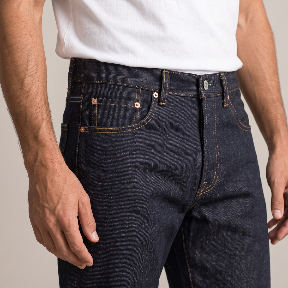Close detail of the front pockets and rivets on the raw selvedge jeans