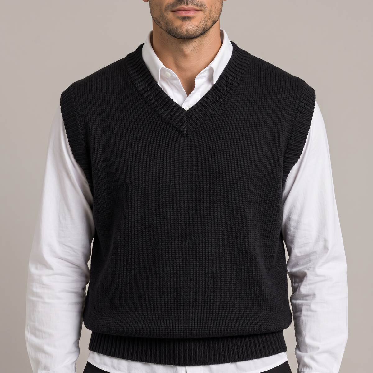 Close-up of the ribbed V neckline over a white shirt collar, in black
