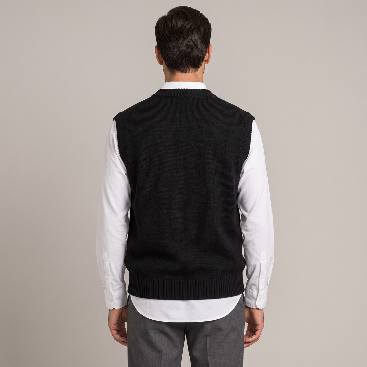 Back view of the relaxed knitted vest in black