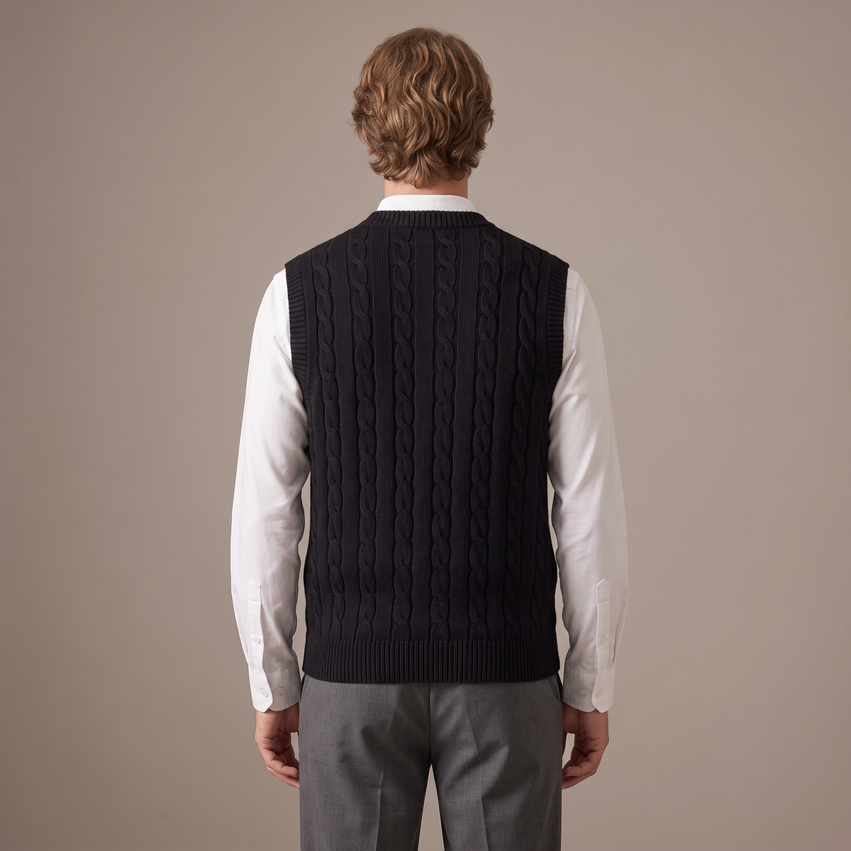 Back view of the cable knit vest in black