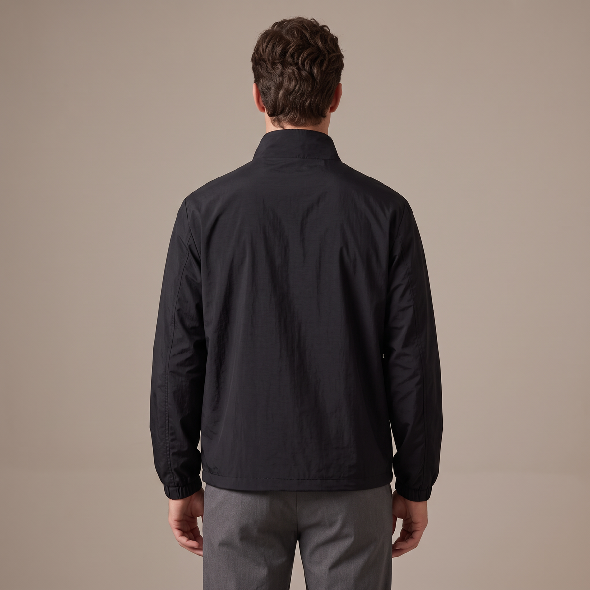 Back view of the windbreaker jacket in black