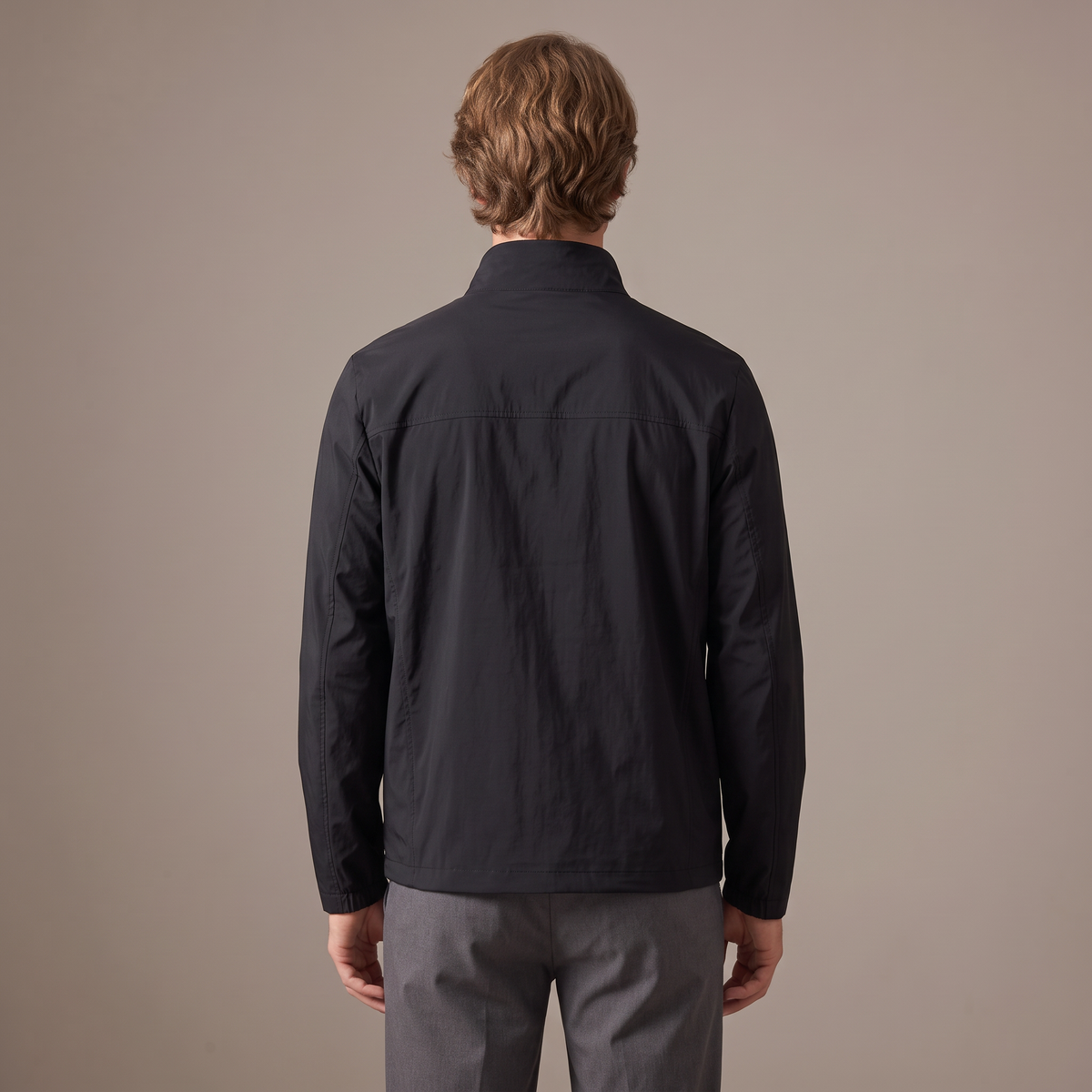 Back view of the windbreaker jacket in black