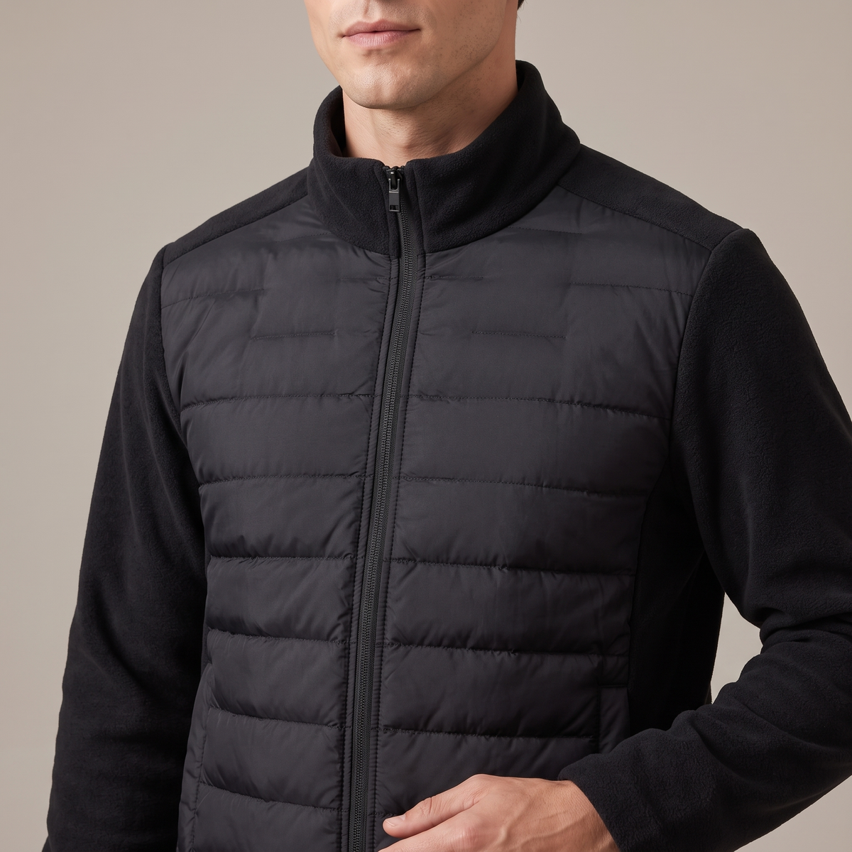 Close-up of the stand collar, zip and quilting, in black