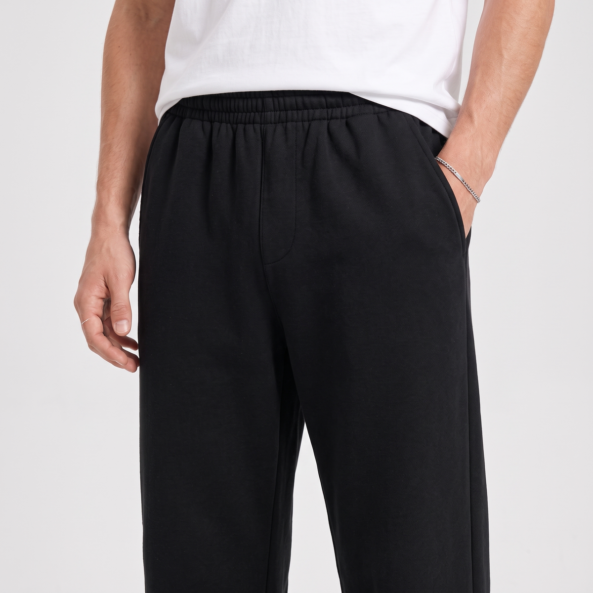 Close-up of the drawstring waistband and pocket, in black
